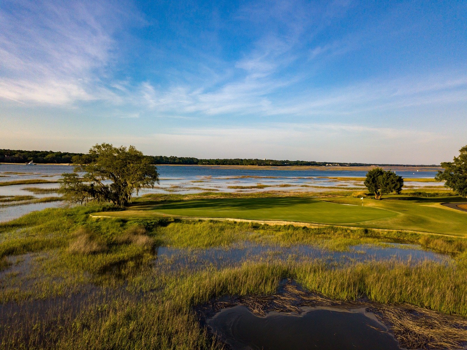 Golf course with marsh and water views